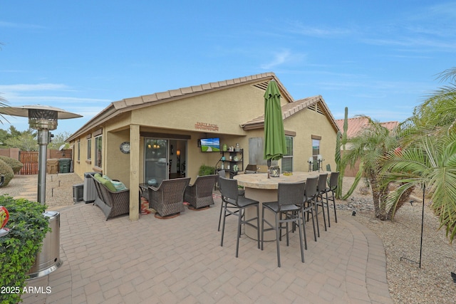 view of patio featuring outdoor lounge area, fence, and outdoor dry bar