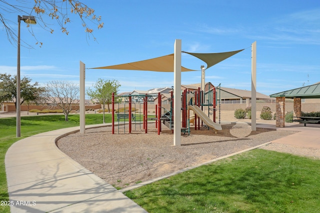 community jungle gym featuring a yard