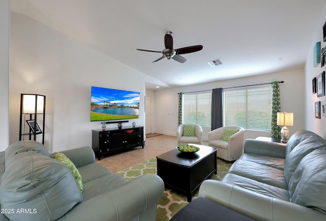 living area with lofted ceiling, visible vents, and ceiling fan