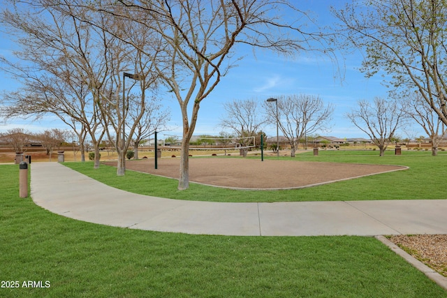 view of property's community with a yard and volleyball court