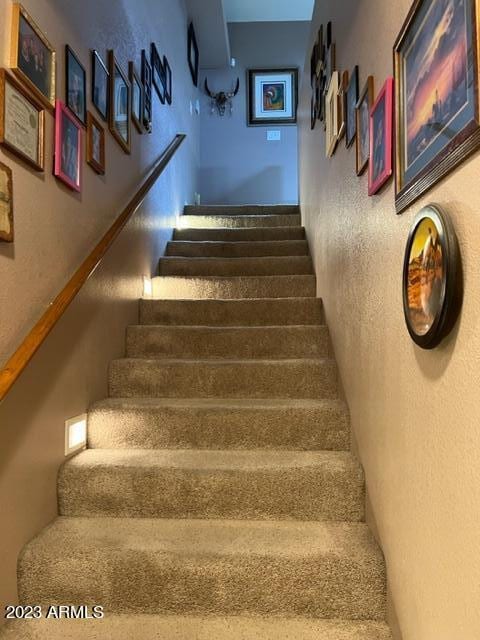 staircase with a textured wall