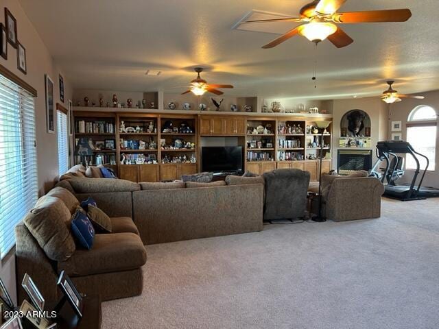 living room featuring carpet and a fireplace