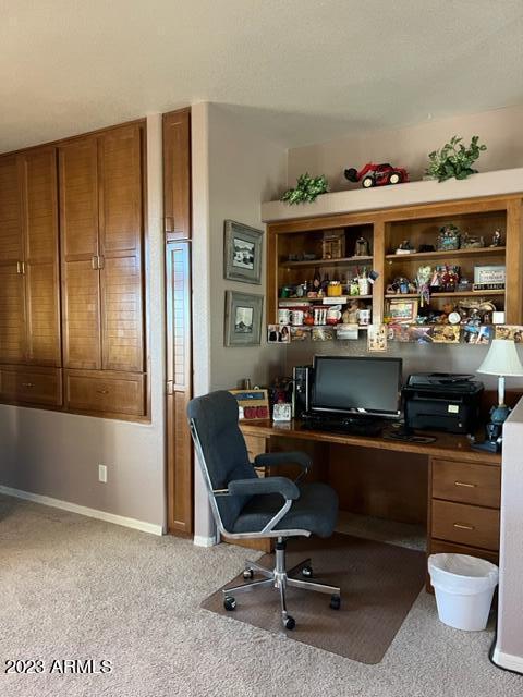 home office with light carpet and baseboards