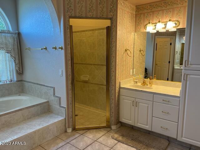 bathroom featuring a garden tub, wallpapered walls, a stall shower, vanity, and tile patterned floors