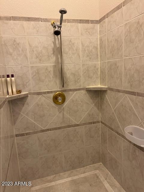 full bath with a tile shower