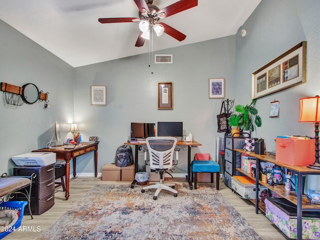 office area featuring ceiling fan, vaulted ceiling, and light wood-type flooring