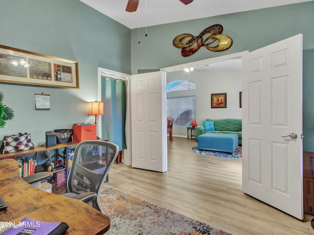 home office featuring ceiling fan and light hardwood / wood-style flooring