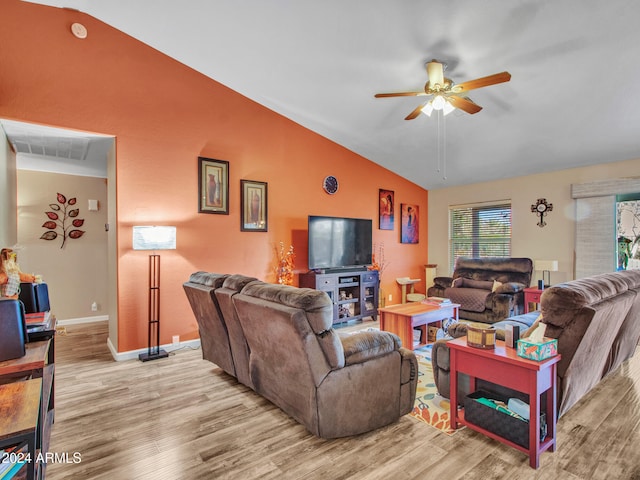 living room with ceiling fan, vaulted ceiling, and light hardwood / wood-style flooring