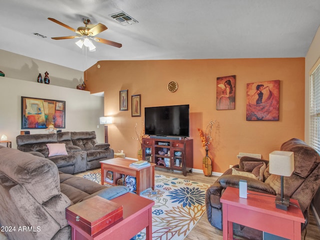 living room featuring vaulted ceiling, light hardwood / wood-style floors, and ceiling fan