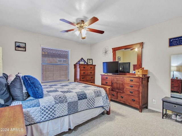 bedroom featuring ceiling fan and light carpet