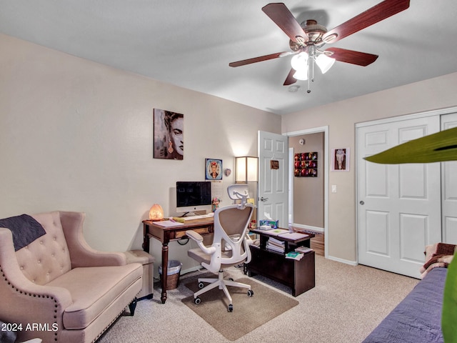 carpeted office space featuring ceiling fan