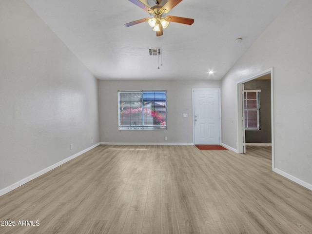 spare room with ceiling fan, lofted ceiling, and light hardwood / wood-style flooring