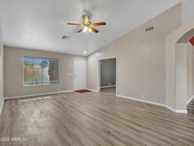 unfurnished living room featuring ceiling fan, lofted ceiling, and light wood-type flooring