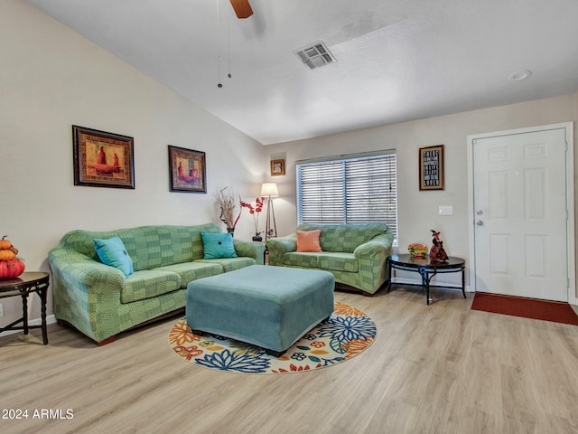 living room with vaulted ceiling, ceiling fan, and light wood-type flooring