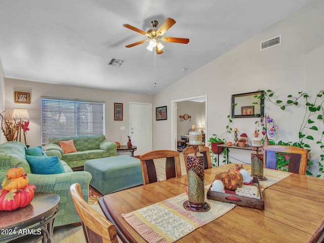 dining space with hardwood / wood-style flooring, vaulted ceiling, and ceiling fan