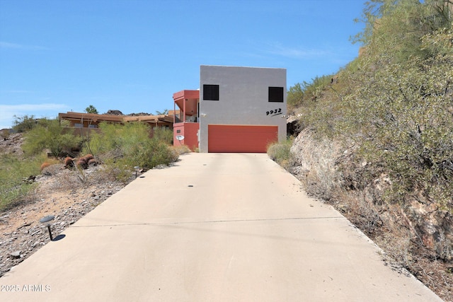 9932 N 16th Pl E, Phoenix, AZ 85020 - view of front of house with a garage, concrete driveway, and stucco siding