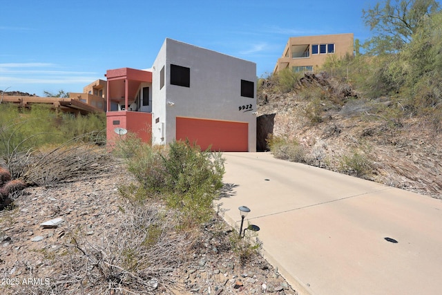 9932 N 16th Pl E, Phoenix, AZ 85020 - view of front of property featuring a garage, stucco siding, and driveway