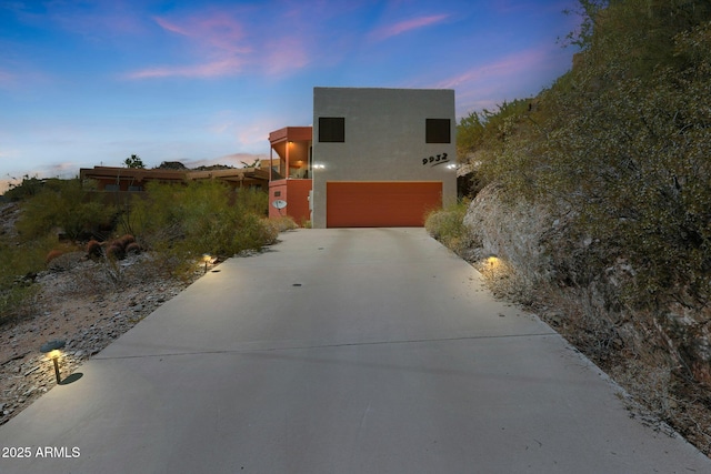 9932 N 16th Pl E, Phoenix, AZ 85020 - pueblo revival-style home with a garage, driveway, and stucco siding