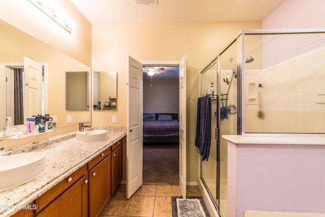 bathroom featuring a shower with shower door, tile patterned floors, and vanity