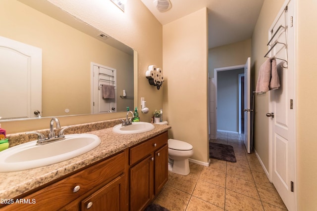 bathroom featuring vanity, toilet, and tile patterned flooring