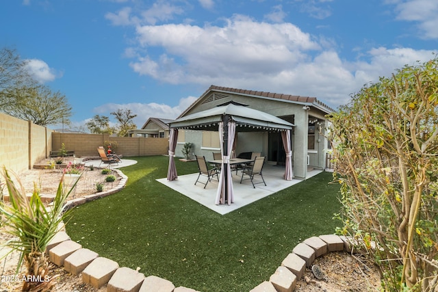 rear view of property with a patio area, a gazebo, and a yard