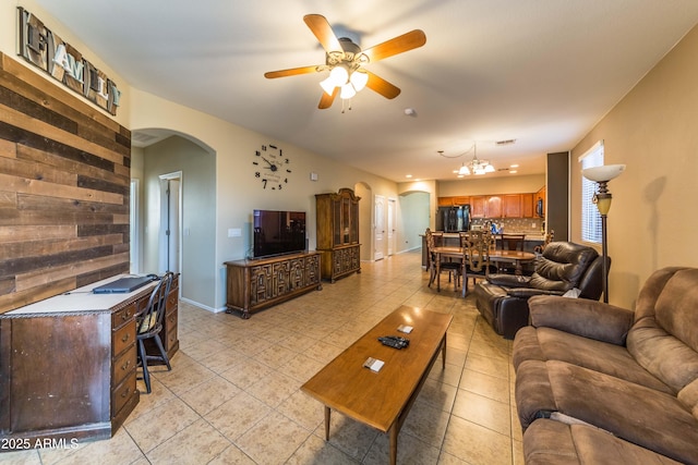 living room with ceiling fan with notable chandelier