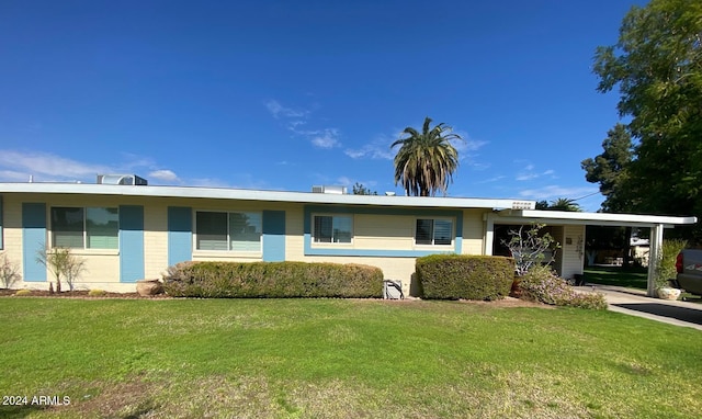 ranch-style home with a front lawn and a carport