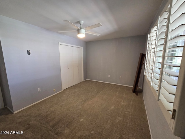 unfurnished bedroom featuring a closet, ceiling fan, and carpet floors