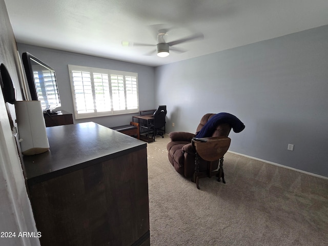 carpeted home office featuring ceiling fan