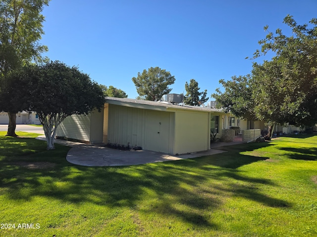 view of property exterior with a lawn