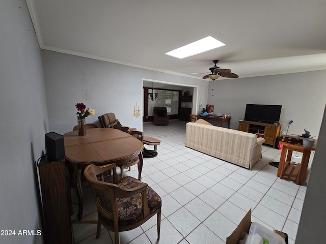 tiled living room featuring ceiling fan and crown molding