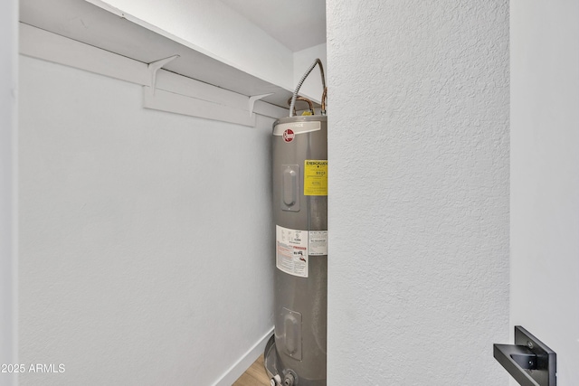 utility room featuring water heater