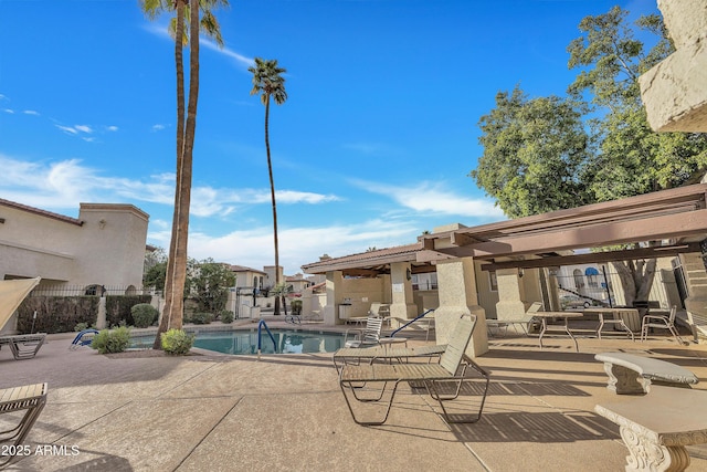 community pool featuring fence and a patio