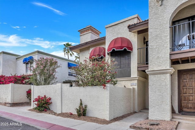 exterior space featuring fence and stucco siding