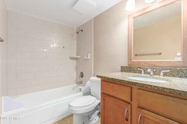 bathroom featuring shower / washtub combination, a textured wall, vanity, and toilet