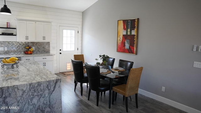 dining space featuring dark wood-type flooring