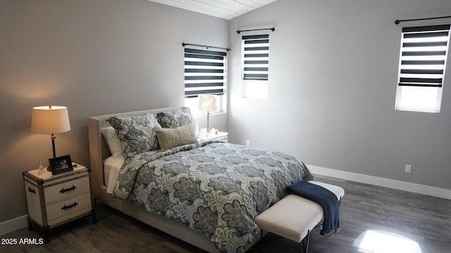 bedroom featuring vaulted ceiling and dark wood-type flooring