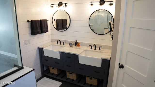 bathroom featuring vanity and wooden walls