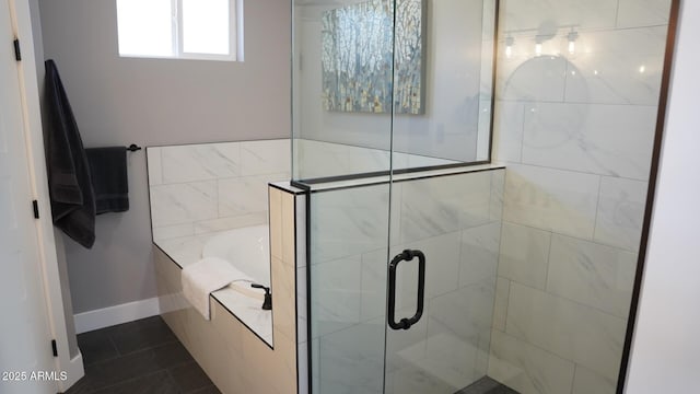 bathroom with separate shower and tub and tile patterned floors