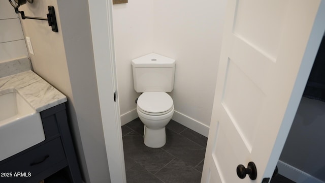 bathroom featuring vanity, toilet, and tile patterned flooring