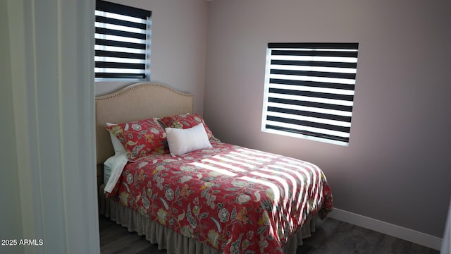 bedroom with dark wood-type flooring