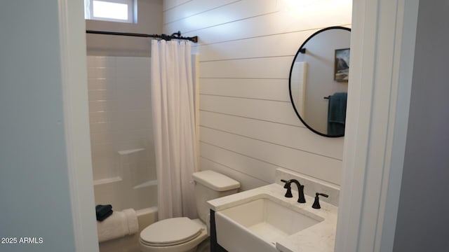 full bathroom featuring shower / tub combo with curtain, vanity, toilet, and wood walls