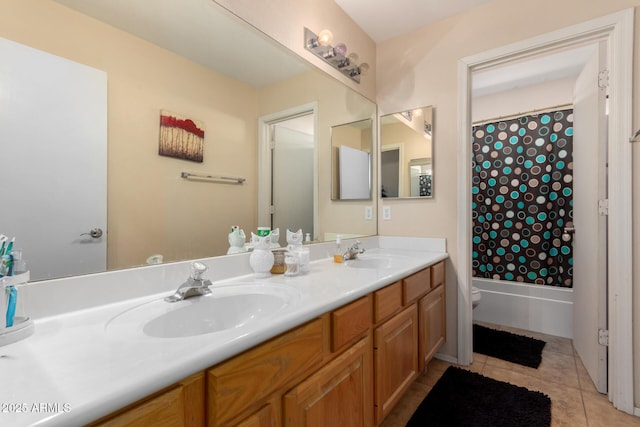full bath featuring toilet, tile patterned flooring, a sink, and double vanity