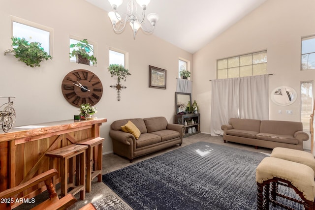 carpeted living room with high vaulted ceiling and an inviting chandelier