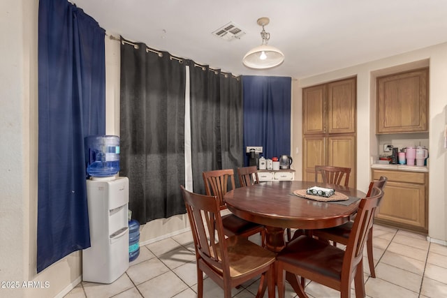 dining area with light tile patterned flooring and visible vents