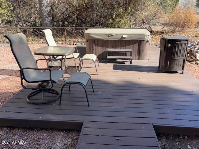 wooden terrace featuring a hot tub