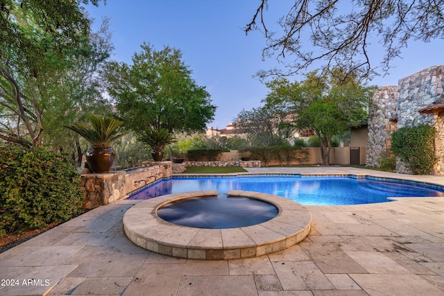 view of swimming pool with an in ground hot tub, a patio, and a fenced in pool