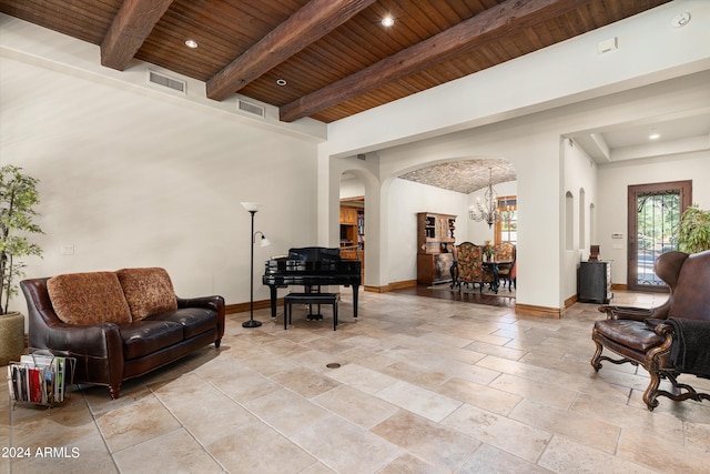 living room with beam ceiling, wooden ceiling, and a chandelier