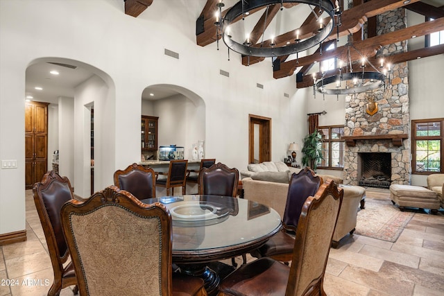 dining area with a high ceiling, visible vents, arched walkways, and stone tile flooring