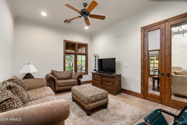 living room with a wealth of natural light, french doors, and ceiling fan